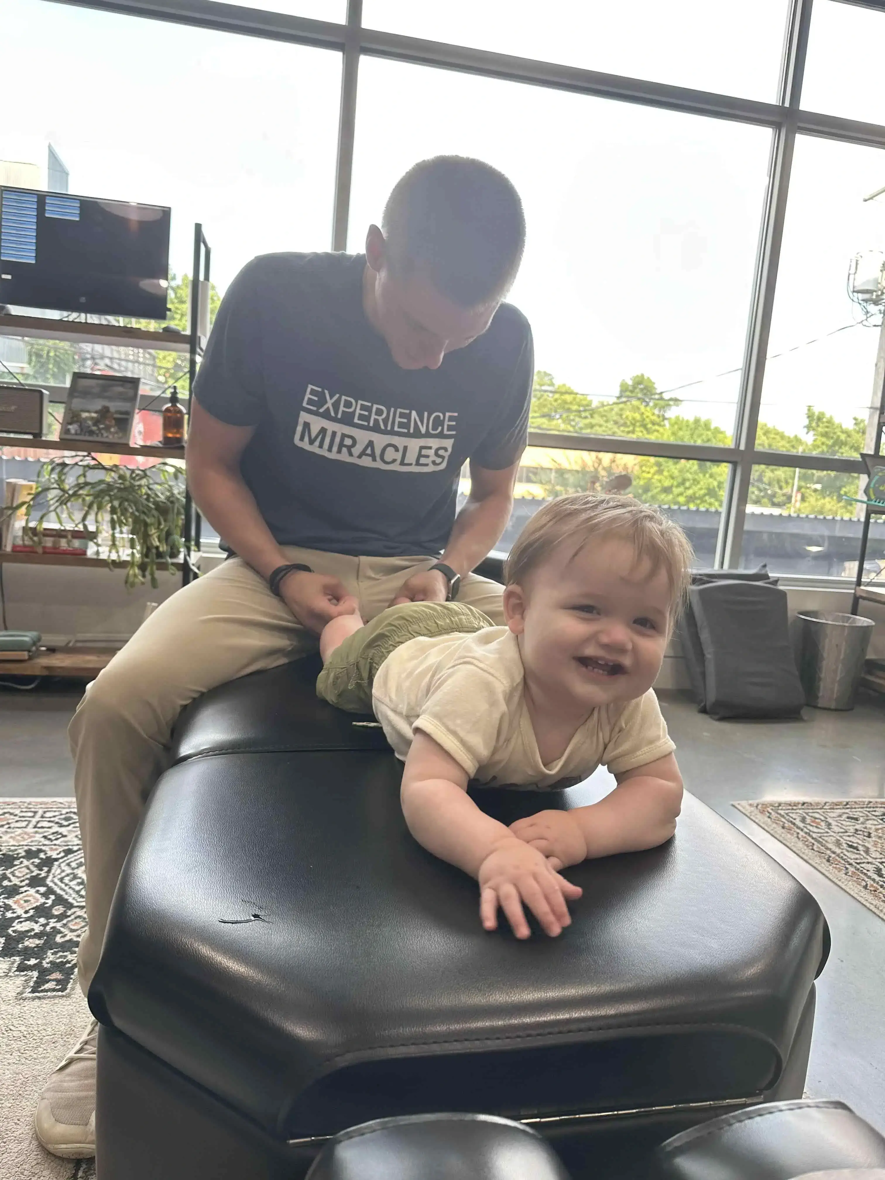 Happy family receiving gentle chiropractic care at Kansas City family wellness center